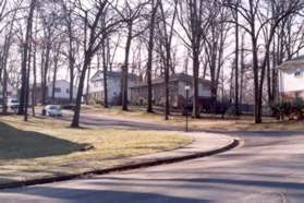 Turn left and follow the sidewalk along Woodland Ct.