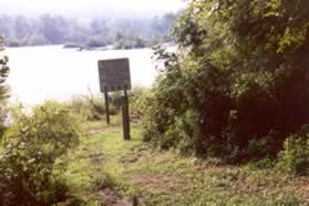 Turn left off the service road and follow the path downstream next to this sign.