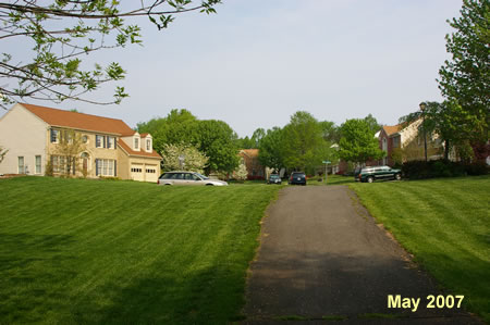 The asphalt trail passes between homes and  ends at Marble Rock Dr.