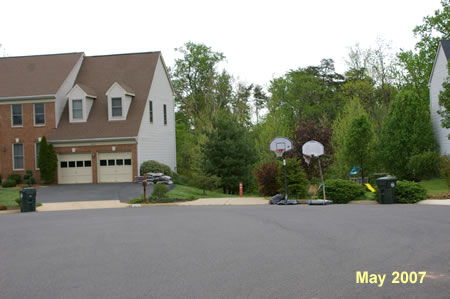 Take the asphalt trail between the houses at the end of the street.