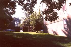 The trail reaches the back of the Stuart Woods Apartments.  Continue to the front of the building.