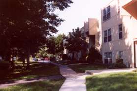 After the tennis court continue along the sidewalk in front of the next building.