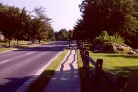 Turn right and follow the sidewalk along Herndon Pkwy with the apartments on your right.