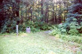 Fron the kiosk walk towards the trail in back of the house.  It is marked 'WOODLAND PATH'.