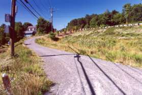 Turn left and follow the gravel road up to the street.