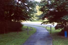 Follow the asphalt trail between the metal barriers at the end of Coat Ridge Rd.