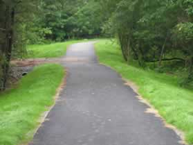 The trail passes through a wooded section with Sugarland Run off to the right.