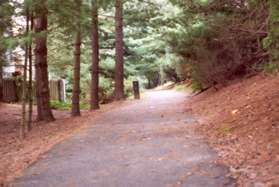 After exiting the tunnel the trail passes by houses on the left.