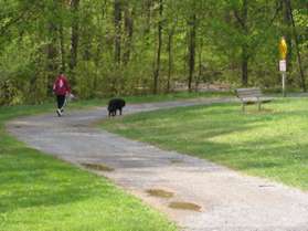 The trail turns and crosses the miniature railroad track.